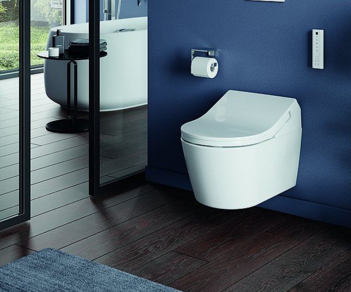 Dusch-WC vor blauer Wand.